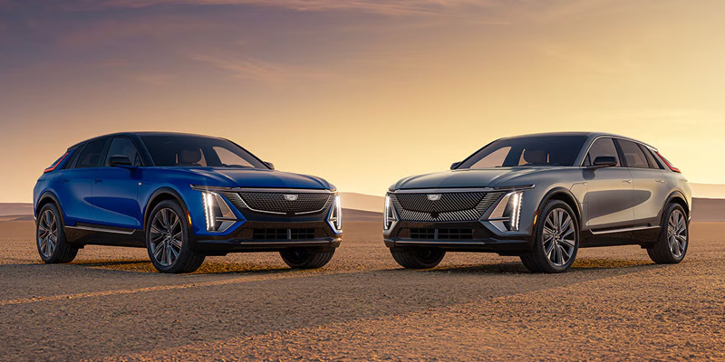 Two Cadillac LYRIQ SUVs side by side at sunset.