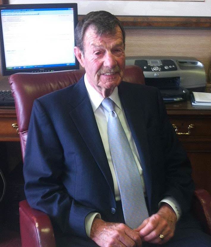 Robert C. Gregory sitted on chair